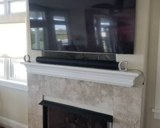 TV with wall mount & sound bar; gas fireplace insert & mantel