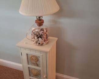 Shell cupboard; table lamp