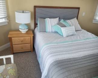 Queen bed; nightstand; table lamp