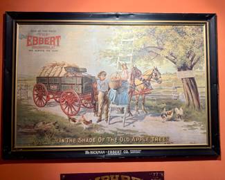 C. 1906. One of the great self-framed tin signs featuring the Hickman-Ebbert Wagon Company of Owensboro, Kentucky. Titled, "In the Shade of the Old Apple Tree". A stunning lithographic image from the golden age of advertising. Marked, "Chas. W. Shonk Co. Litho. Chicago. No. C. 1028", lower right corner. Marked, "Design by U.S.G. Clemens, Copyright 1906", lower left corner.