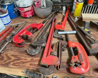 Lots of old wrenches and pipe cutters
