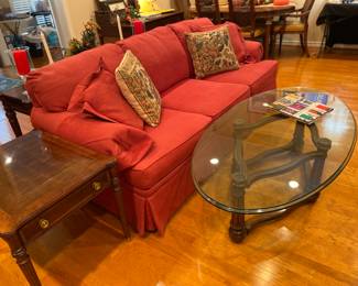 Red sofa and retro glass & wood coffee table