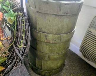 vintage or antique wooden bucket, often referred to as a "dry measure" or "staved buckets  used for measuring dry goods like grain in general stores and by merchants. 
The construction is made of staved wood with metal or iron bands. 
