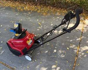 Toro Power Clear Red Electric Snow Blower with Safety Labels and Adjustable Handle
