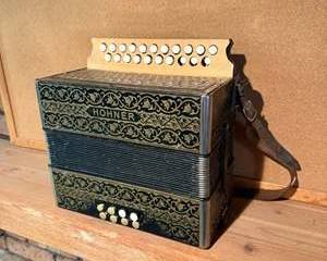 Antique Hohner Button Accordion, Made in Germany with Ornate Black and Gold Design