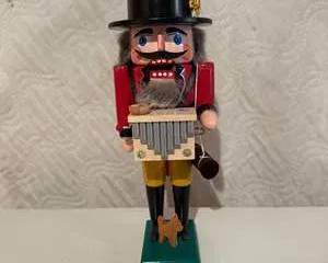 Traditional Wooden Nutcracker Figurine with Panpipes and Dog on Green Base