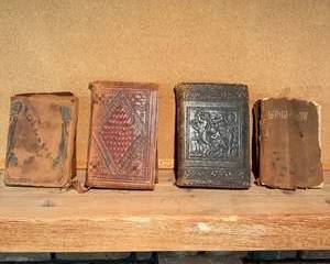 Set of Four Vintage Leather Bound Books with Embossed Covers and Aged Pages