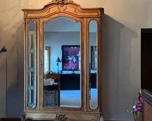 Majestic Wooden Armoire with Large Central Mirror and Intricate Carved Details