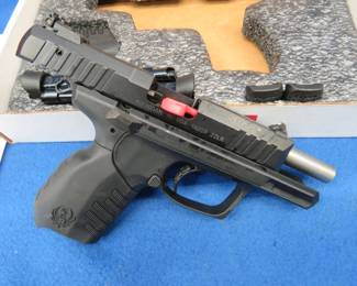 Lot 24. Ruger SR22, 22LR semi-auto pistol. S/N: 367-30446. Includes two magazines, extra back straps, lock, and original case.