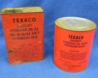 Lot 380. Two one-gallon cans of Texaco aircraft hydraulic oil. The square one has some liquid in it, and the round one is unopened