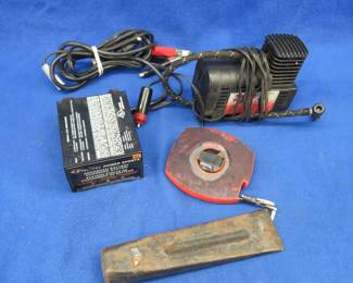 Lot 202. Deka 2A charger, 12v inflator, splitting wedge, and a 100' measuring tape