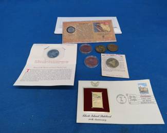 Lot 292. Collectible coins and more: $5 Heroes of Desert Storm coin. Sacagawea gold-plated official cover. First Day Cover Rhode Island May 29,1990. And more.