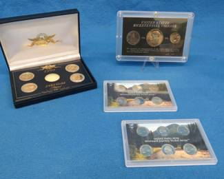 Lot 294. Four collectible coin sets: Five 1999 24kt gold-plated state quarters. U.S. Bicentennial coin set. 2004 and 2005 Westward Journey Nickel Series.