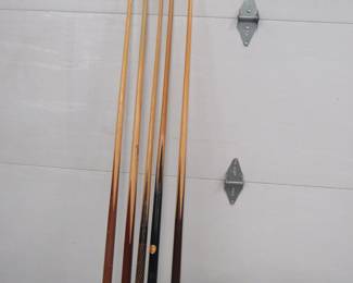 Lot 272. Five pool cues