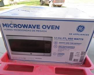 Lot 229. Appears NIB GE Microwave
