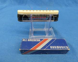 Lot 245. Harmonic Reed Co.10-hole Unitone shiftless inline chromatic harmonica in an All American box.