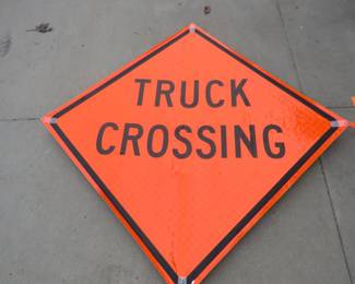 Lot 374. Foldable truck crossing sign and a safety vest
