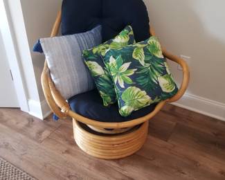 Rattan swivel chair; tropical cushions
