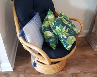 Rattan swivel chair; tropical cushions