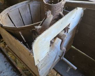 Early corn sheller mounted on a box.