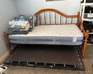 Trundle bed shown with bedding folded up so you can see the lovely mattress and the pull out lower mattress holder