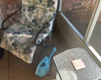 Various outdoor furniture, including a table, chair, and even a watering can for your gardening needs!
