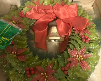 Christmas wreath decorated with holly leaves, red berries, and poinsettia flowers