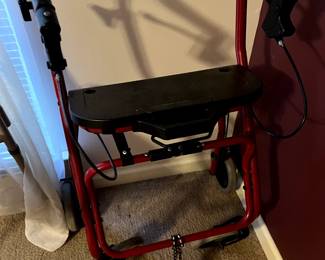 red rollator walker with a seat and handbrakes
