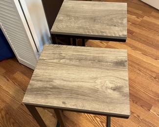 $60 Pair of contemporary metal and laminate side tables; 26” high x 12” wide x 15” deep. 