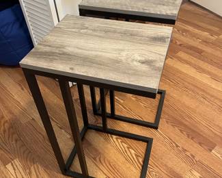 $60 Pair of contemporary metal and laminate side tables; 26” high x 12” wide x 15” deep. 