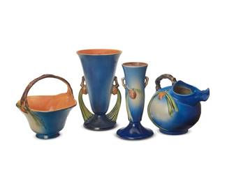 2099
Four Roseville pottery 'Blue Pinecone' vessels
Mid-20th century
Each marked for Roseville and variously numbered: 705-9 / 1321 / 747-10 / 409-8
Designed 1931, each with pinecone motifs in relief on a blue ground, comprising a footed vase with opposed branch-form handles (9.5" H x 4.875" Dia.), a pitcher with ice lip and branch-form handle (7.5" H x 8.5" W x 7" D), a footed vase with opposed pine needle-form handles (10.625" H x 6.375" Dia.), and a handled basket (8.375" H x 8.375" W x 8.25" D)
4 pieces
Estimate: $400 - $600