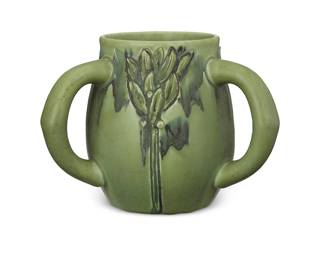 2101
A Rookwood pottery vase
1907; designed by Albert Pons
Marked for Rookwood; further marked: VII / 659C; incised signature: AP [Albert Pons (1888-1972)]
The ceramic vase with 'Modeled Mat' glaze, featuring three handles and three foliate forms in relief
6.375" H x 8.75" W x 7.75" D
Estimate: $400 - $600