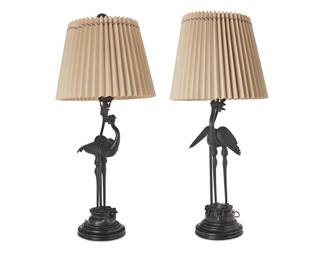 2215
A pair of Chinese bronze figural candlestick table lamps
20th century
Each two-light lamp depicting a patinated bronze Manchurian crane with floral branch in its mouth issuing a candleholder, mounted on a wood base and surmounted by a fabric-lined paper shade with passementerie trim, electrified
2 pieces
Taller lamp: 40.5" H x 10" Dia. approx.; Each shade: 13.5" H x 18.25" Dia.
Estimate: $400 - $600