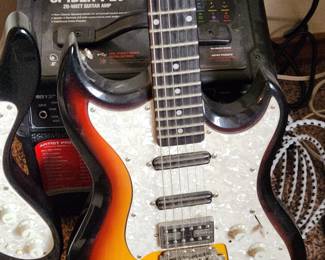 Hagstrom Ultra Swede Electric Guitar and in the background a Line 6 Spider 20-watt Modeling Combo Amplifier. 