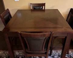 Counter top table with four leather chairs looks NEW