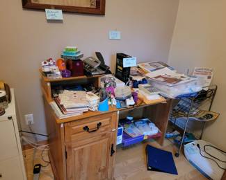 Desk and lots of supplies and lots of photo copy paper