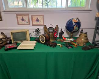 Globe on stand, chiming clock, large brass French bell, brass compass with side oil lamps from a ship, alien warrior comprised of hardware components