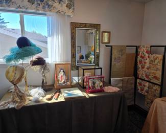 Upstairs bedroom - more old store stock hats circa 1920; fine textiles on rack
