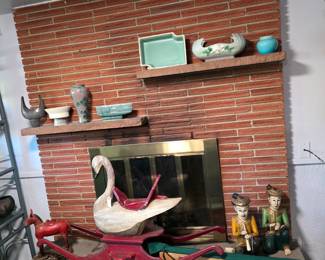 Goose rocker, a selection of mid-century pottery, and carved wood figures.