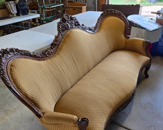 A Victorian carved wood upholstered sofa in excellent condition.