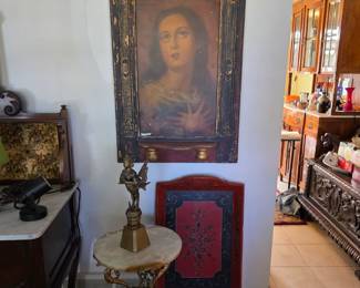 Antique portrait of a saintly female with a carved wood frame. 