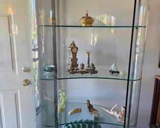 Beautiful vintage contoured lighted glass showcase! The Van Briggle clam pottery piece is on bottom shelf