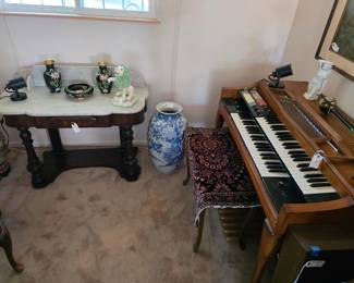 Antique marble top washstand, Thomas organ with bench, small Persian rug, large Asian blue and white vase.