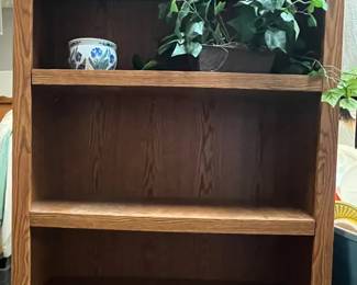Bookshelf/ Home Decor
Classic wooden bookshelf with warm finish, perfect for home, office, or library use. Offers plenty of storage & display space for books, décor, or collectibles. Includes two decorative accents currently displayed on the shelves:
