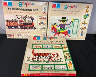 1969 Tupperware Toys “SnaPics” – 3 Boxed Sets
Take a step back to the late 1960s with these colorful Tupperware Toys “SnaPics” sets. Each set includes plastic tiles that snap into boards to create vibrant pictures—a creative & fun activity that entertained kids long before video games. These are highly collectible today, both for vintage toy enthusiasts & Tupperware collectors.
﻿Market Insights: Vintage SnaPics sets from the late 1960s are increasingly scarce. Depending on completeness, individual sets have sold from $30–$60 each online, with full or multiple boxed sets often commanding $100+. Even as-is, these retain strong appeal due to their rarity & nostalgic crossover between toys & Tupperware collectibles.

Includes:
(1) Animal Kingdom Set No. 204
(1) Set No. 201 (cowboy/horse theme shown on cover)
(1) Transportation Set No. 203
Condition: Unsure if sets are complete; selling as shown in photos. Boxes show some age wear but graphics remain bright.
