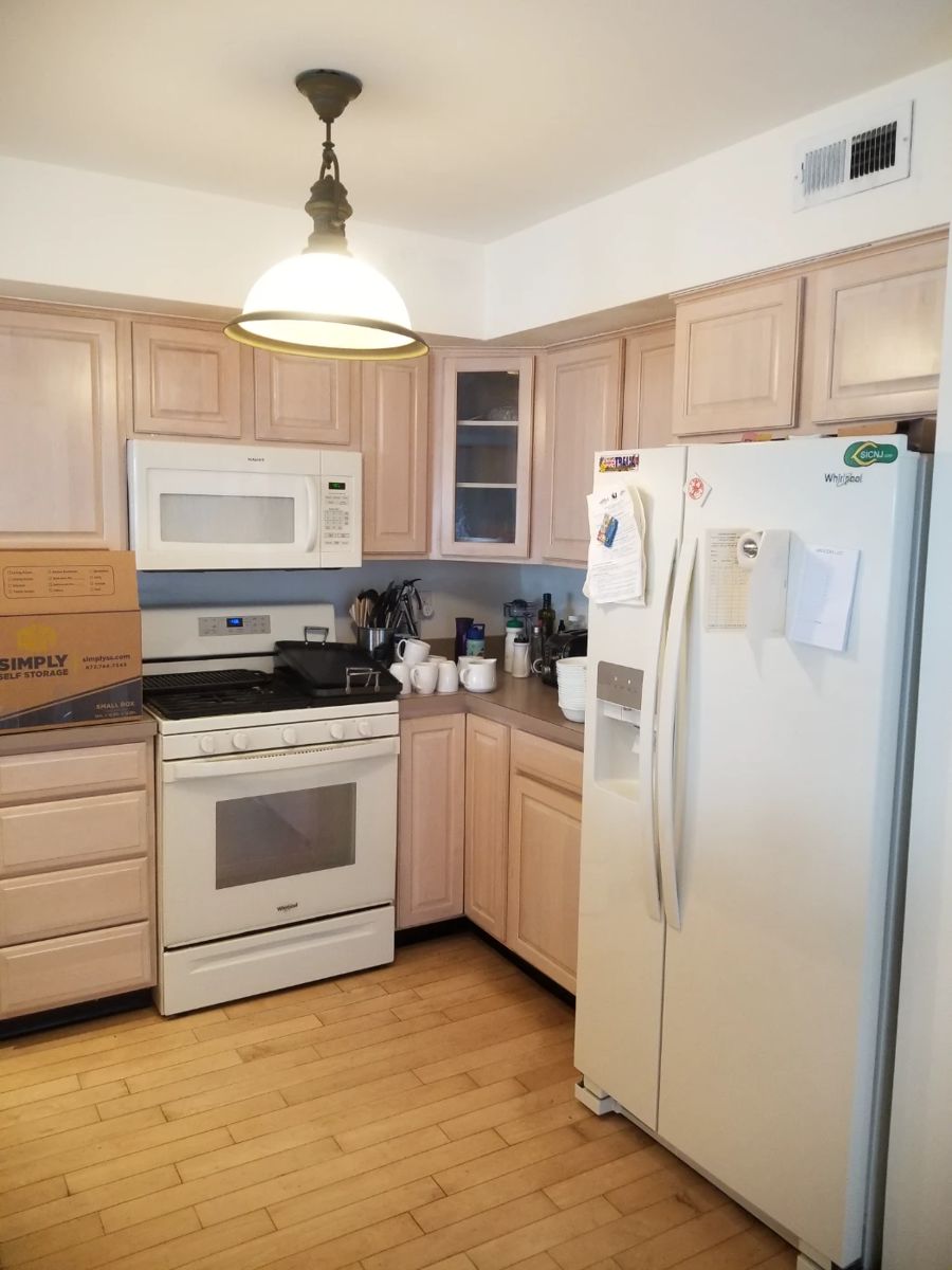 Two U-shaped kitchens - each a mirror image of the other. Whirlpool refrigerator; Whirlpool range