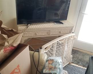 Wicker table; TV; baby gate