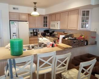 Two U-shaped kitchens - each a mirror image of the other. Whirlpool refrigerator; Kenmore range