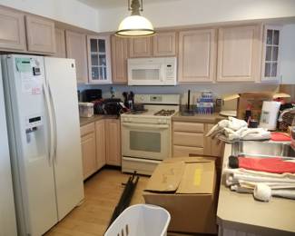 Two U-shaped kitchens - each a mirror image of the other. Whirlpool refrigerator; Whirlpool range