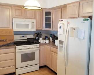 Two U-shaped kitchens - each a mirror image of the other. Whirlpool refrigerator; Whirlpool range